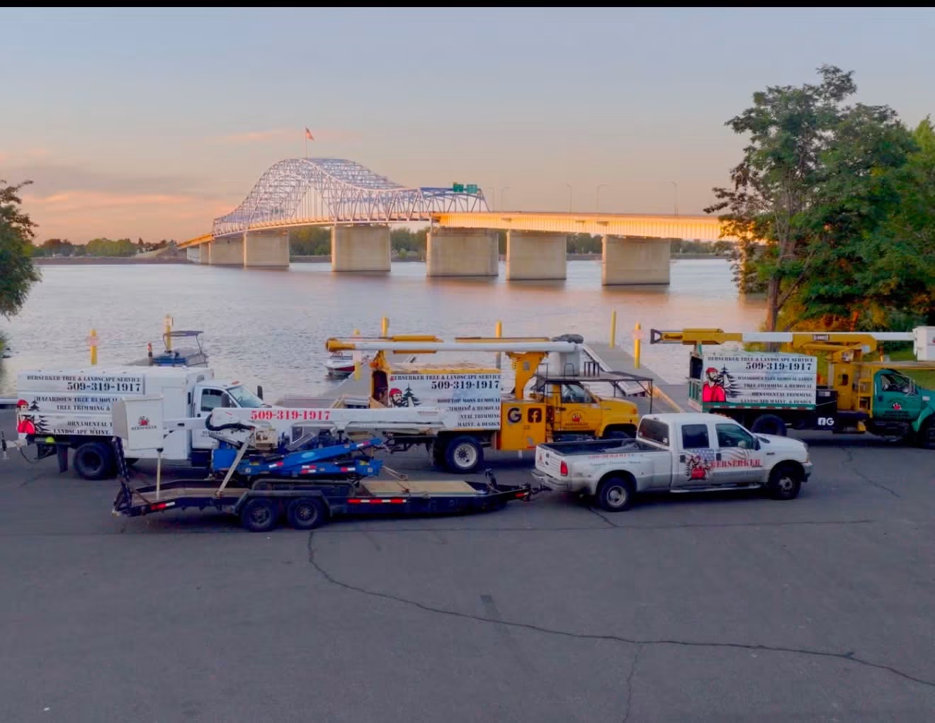 Berserker Tree & Landscape Service fleet parked along the Columbia River with the blue bridge in Richland, WA